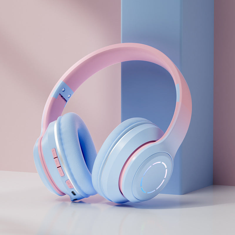 Auriculares Bluetooth plegables en rosa y azul con controles de volumen y micrófono integrado
