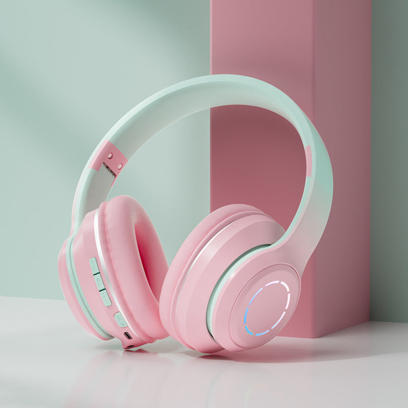 Auriculares Bluetooth plegables en color rosa y blanco con controles incorporados para facilitar su uso